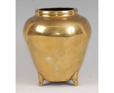 A Chinese cast polished bronze tripod vase, of ovoid tapering form, supported on three small applied feet, bearing incised si