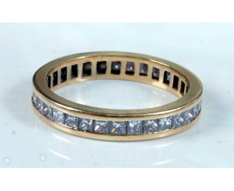 An 18ct yellow gold diamond full hoop eternity ring, featuring thirty-three Princess cut diamonds in channel settings, each a