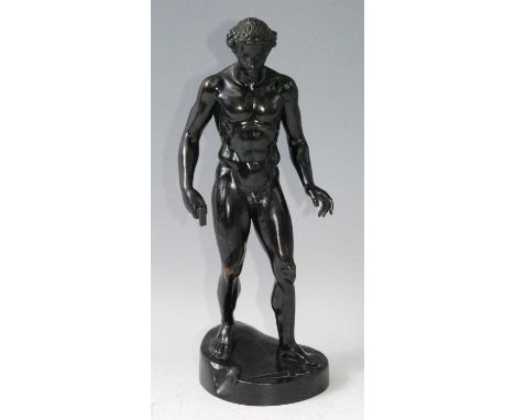 A circa 1900 bronze of a male nude, in standing pose with mallet in his right hand and sword at his feet, of deep-brown patin