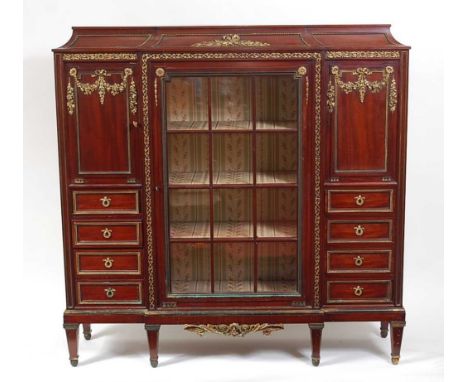 A circa 1900 French mahogany and gilt bronze mounted breakfront side cabinet, the glazed centre section enclosing silk lined 