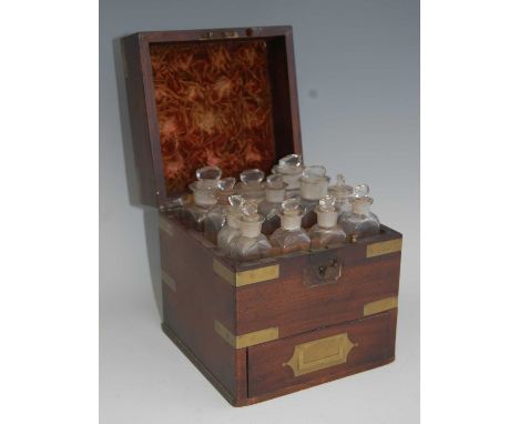 A 19th century mahogany and brass bound travelling apothecary case, the hinged lid with brass corners and recessed handle, op