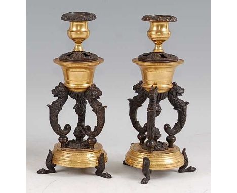 A pair of late 19th century French bronze and gilt bronze candlesticks, the floral cast removable sconces over pastille burne