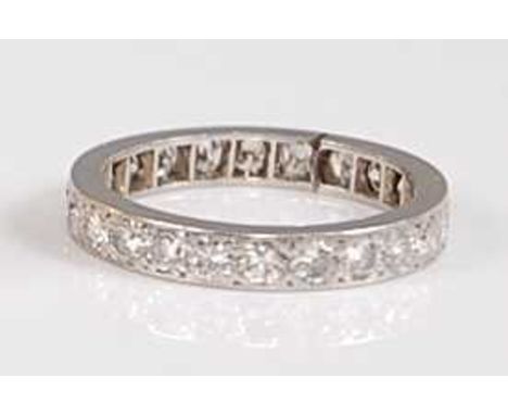 A white metal full hoop eternity ring, comprising twenty-four round brilliant cut diamonds in millegrain settings, diamond di