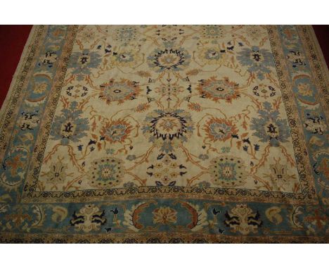 A Turkish Ushak woollen carpet, the cream ground decorated with stylised flowers and foliage within trailing tramline borders