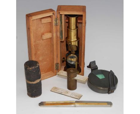 An early 20th century lacquered brass students monocular microscope, in fitted oak case with accessories to inc. spare lens, 