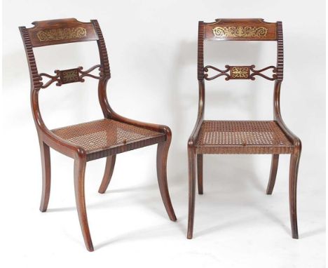A pair of Regency rosewood and brass inlaid barback dining chairs, each having split cane seats and raised on brass strung sa