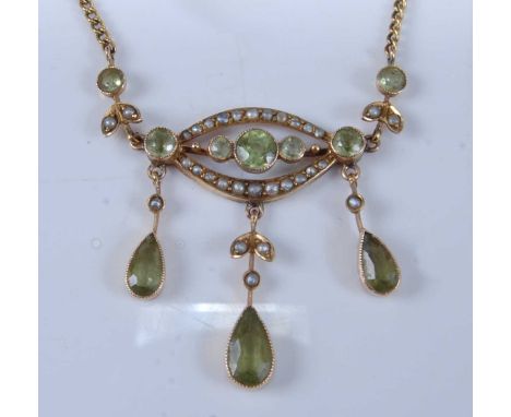 A 9ct yellow gold Edwardian style peridot and seed pearl pendant, comprising three pear shaped and seven round faceted perido