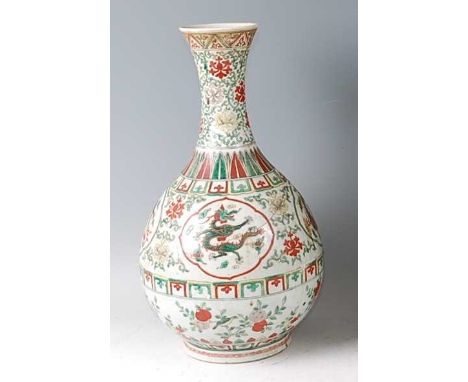 *A Chinese porcelain bottle vase,  in the famille verte palette, brightly enamel decorated with reserves of five-claw dragons