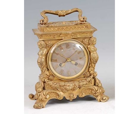 A mid-19th century French gilt bronze mantel clock, in the Louis XIV taste, with swing carry handle, the case cast with two f