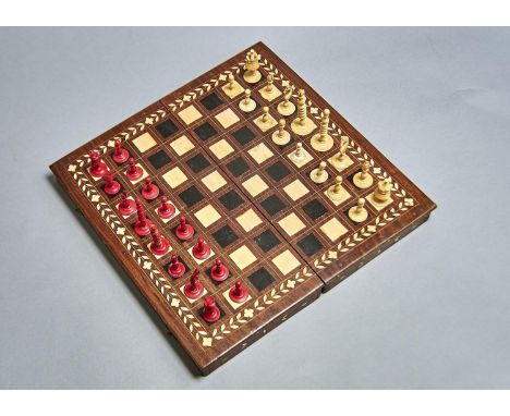 A BONE CHESS SET, 19TH C, STAINED RED AND NATURAL, KINGS 7CM H AND AN EBONY AND BONE INLAID HARDWOOD FOLDING GAMES BOARD (33)
