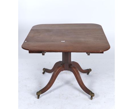 A VICTORIAN MAHOGANY TABLE, C1840, THE DROP LEAF TOP ON OCTAGONAL PILLAR AND QUADRUPLE REEDED LEGS WITH BRASS CAPPED CASTORS,