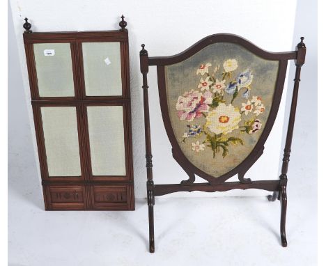 A VICTORIAN WALNUT MIRROR OF SEGMENTAL DESIGN WITH FLUTED AND ROUNDEL CARVED FRIEZE, CHANNELED FRAME, FITTED FOUR BEVELLED MI