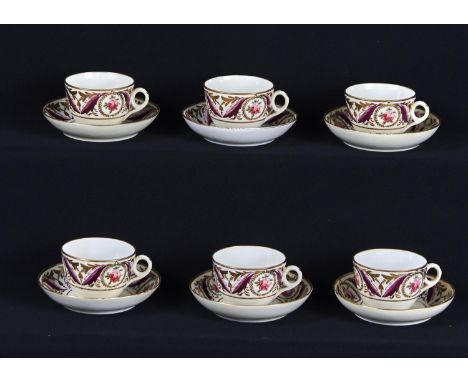 A SET OF MINTON TEACUPS AND SAUCERS, C1810, THE BORDER PAINTED WITH GILT WREATH MEDALLIONS OF SINGLE ROSES FLANKED BY PURPLE 