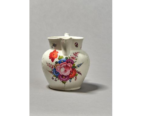 A COALPORT FLORAL RELIEF MOULDED WATER JUG, C1825, BOLDLY PAINTED WITH COLOURFUL SPRAYS AND SCATTERED FLOWERS, THE CRABSTOCK 