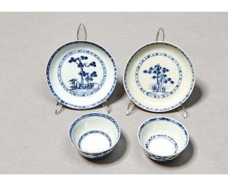 TWO CHINESE NANKING CARGO BLUE PINE PATTERN TEA BOWLS AND SAUCERS OF THE LARGE SIZE, C1750, PAINTED WITH TWO PINE TREES ABOVE