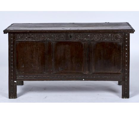 A LATE 17TH C OAK BLANKET CHEST, THE RECTANGULAR TOP WITH MOULDED LIP ABOVE A ROUNDEL CARVED FRIEZE, PLAIN THREE PANEL FRONT 