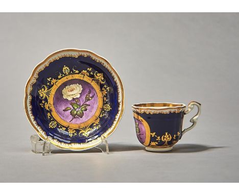 A SAMUEL ALCOCK BLUE GROUND COFFEE CUP AND SAUCER WITH MELTING SNOW BORDER, C1820, FINELY PAINTED WITH A ROSE ON A SHADED PUR