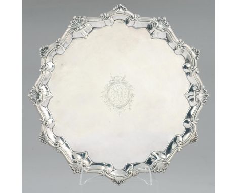 A GEORGE III SILVER SALVER ENGRAVED WITH INITIALS AC AND CREST IN MOULDED BORDER WITH SHELLS AT INTERVALS,&nbsp; ON THREE VOL