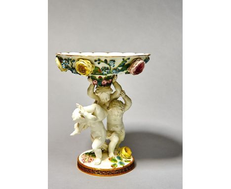 A MOORE BROTHERS FLORAL ENCRUSTED FRUIT STAND, C1870, THE SHALLOW SCALLOPED GILT DISH SUPPORTED BY THREE PLAYFUL CHILDREN ON 