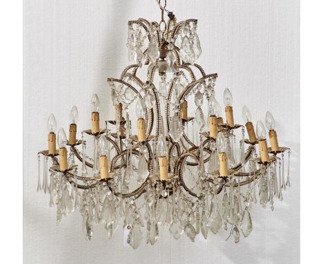 AN EIGHTEEN LIGHT AND GILTMETAL CHANDELIER IN LATE 18TH C STYLE, IN TWO TIERS WITH CENTRAL OBELISK HAVING BEADED, SCROLLING B
