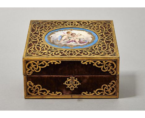 A VICTORIAN PIERCED GILT BRASS AND VELVET COVERD STATIONERY BOX, C1870, THE SLOPING LID MOUNTED WITH AN OVAL SEVRES STYLE BLE