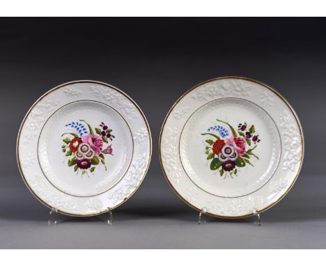 A PAIR OF ENGLISH PORCELAIN FLORAL MOULDED DESSERT PLATES, C1820, PAINTED WITH A CENTRAL GROUP OF FLOWERS, 21CM DIAM Conditio
