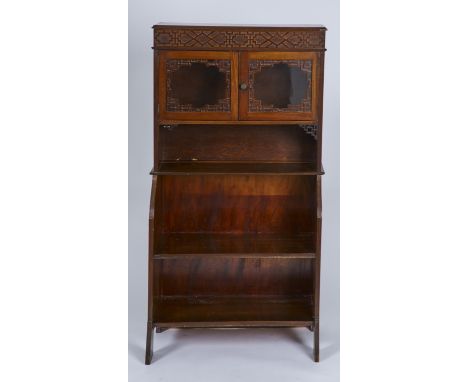 AN EDWARDIAN MAHOGANY BOOKCASE, C1905, THE TOP WITH GEOMETRIC BLIND FRET FRIEZE ABOVE PAIR OF GLAZED DOORS, APPLIED FRET CUT 