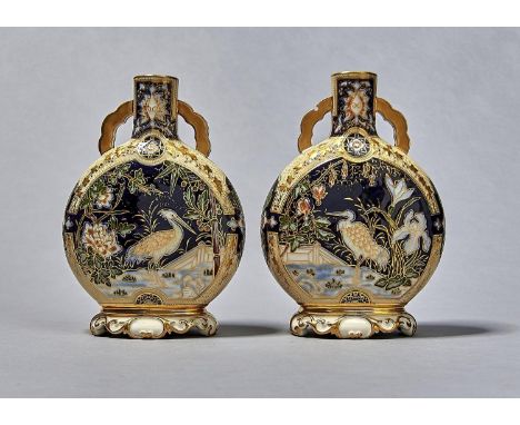 A PAIR OF ROYAL WORCESTER JAPONISME PILGRIM FLASKS, 1877, MOULDED IN SHALLOW RELIEF WITH A HERON, MOTH, BAMBOO AND BLOSSOM ON