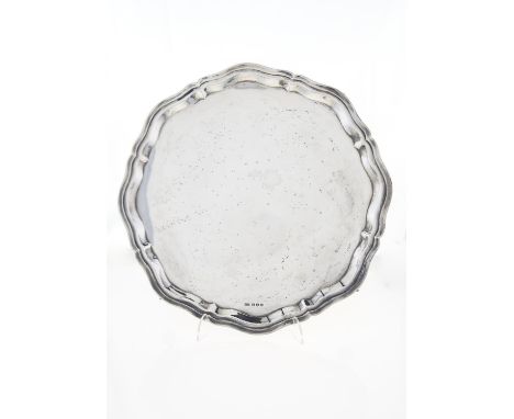 A GEORGE VI SILVER SALVER, ON FOUR LEAF CAPPED VOLUTE FEET, 36CM DIAM, BY VINERS LTD, SHEFFIELD 1938, 34OZS 10DWTS Condition 