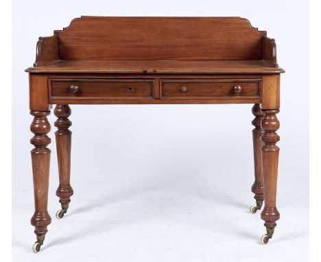 A VICTORIAN MAHOGANY WASHSTAND, WITH SHAPED THREE QUARTER GALLERY, FITTED TWO PANEL DRAWERS ON TURNED TAPERED LEGS, FITTED BR