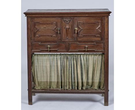 A JACOBEAN REVIVAL OAK CUPBOARD, C1920, THE RECTANGULAR TOP ABOVE A PAIR OF CUPBOARDS WITH APPLIED GEOMETRIC MOULDINGS, FLANK