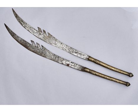 A PAIR OF SOUTH EAST ASIAN SWORDS, 19TH / EARLY 20TH C, THE SHEET BRASS REPOUSSE COVERED GRIP DECORATED WITH WINGED BEASTS AN
