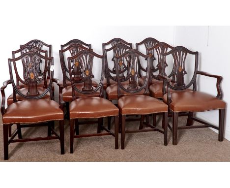 A SET OF TWELVE VICTORIAN MAHOGANY DINING CHAIRS, LATE 19TH C, THE STUFFED OVER SEATS COVERED IN BROWN HIDE, THE SHIELD BACK 