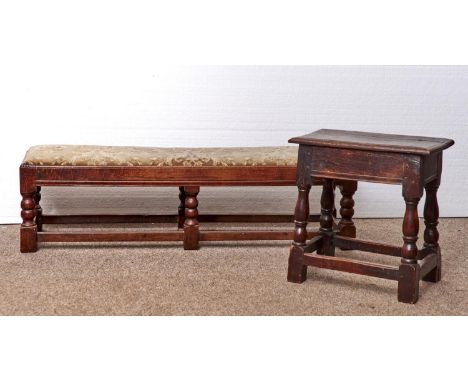 A JOINED OAK LONG STOOL, 17TH STYLE WITH MOULDED RAIL, ON SIX BOBBIN TURNED LEGS AND BLOCK FEET, WITH STRETCHERS, 30CM H; 32 