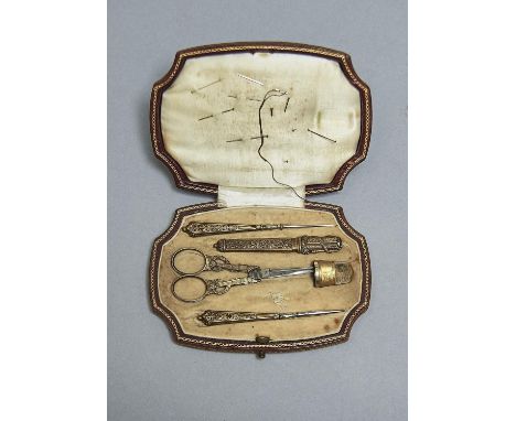A FRENCH SILVER GILT FITTED AND GILT TOOLED BROWN LEATHER NECESSAIRE, C1910, THE NEEDLEWORK TOOLS COMPRISING TWO BODKINS, BOD