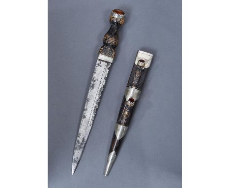 A SCOTTISH EPNS MOUNTED CARVED AND STAINED WOOD AND BLACK LEATHER HIGHLAND DIRK AND SHEATH, C1900, SET WITH CITRINES TO THE P