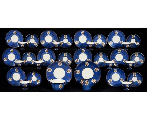 A CZECHOSLOVAKIAN BLUE GROUND PORCELAIN TEA SERVICE, 1920-39, DECORATED WITH MEDALLIONS OF ROSES IN GILT AND PANELLED BORDER,
