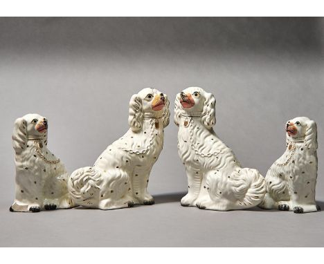 TWO GRADUATED SIMILAR PAIRS OF&nbsp; STAFFORDSHIRE EARTHENWARE MODELS OF SPANIELS, C1860, 23.5 AND 32CM H Condition reportOne