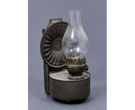 A BRITISH MADE WALL HANGING OIL LAMP, THE BACKPLATE WITH CIRCULAR FLUTED REFLECTOR, THE CYLINDRICAL RESERVOIR WITH ENGLISH BU