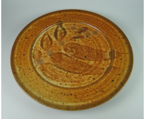 DAVID LLOYD JONES STUDIO POTTERY PLATE of circular form with mottled glaze and traced leaf decoration, potter's mark, 29cms d