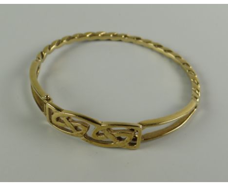 A 9CT GOLD LADIES CELTIC & TWIST DESIGN BANGLE, 13.4grams approx.