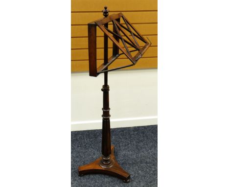 LATE NINETEENTH CENTURY ROSEWOOD MUSIC STAND having turned finial above ratchet design adjustable music stand raised on taper