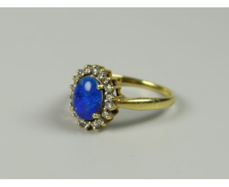 A YELLOW GOLD (MARKS UNCLEAR) BLUE OPAL RING WITH DIAMOND SURROUND, 4grams approx, (size Q)