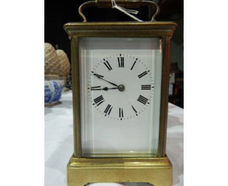 Early 20th century brass carriage clock, plain enamel dial, Roman numerals, having French gong striking movement, 18cm high o