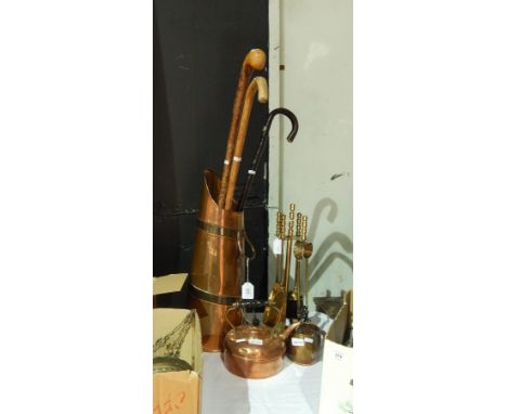 A collection of copper kettle, jug and stick holder with sticks and a companion set 