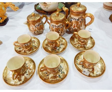 Japanese Satsuma pottery coffee pot with dragon spout, covered sugar basin and covered milk jug, all decorated with panels of