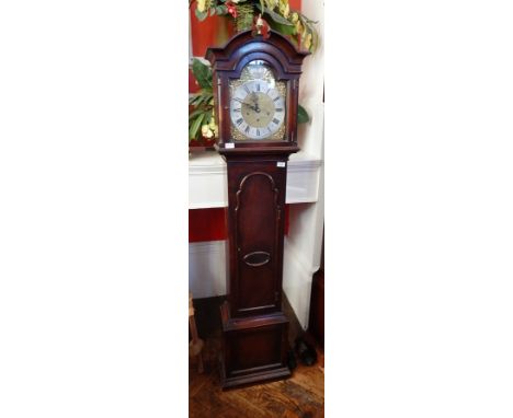 A small oak longcase clock with silvered chapter ring and triple train chiming movement, the cased door with pendulum window,