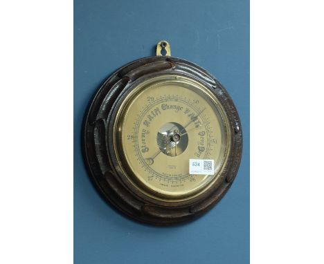 Dollond London aneroid barometer in carved oak case, D25cm CLOCKS & BAROMETERS - as we are not a retailer, these items are so