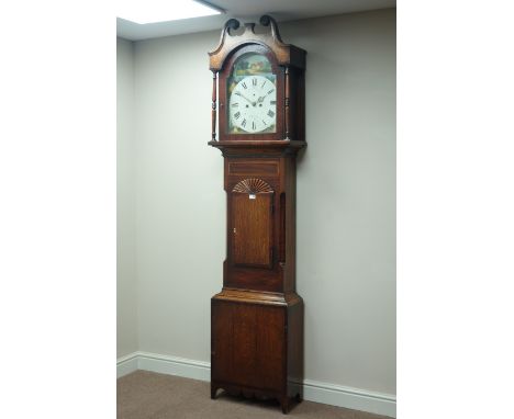 Early 19th century oak and mahogany banded longcase clock, carved fan pediment, eight day movement, dial painted with country