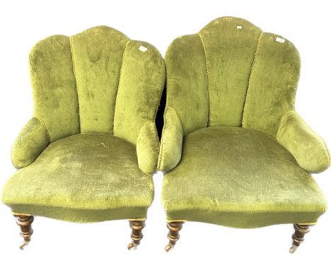 Pair of art deco cushioned chairs, covered in a green upholstery, raised on turned tapered legs 